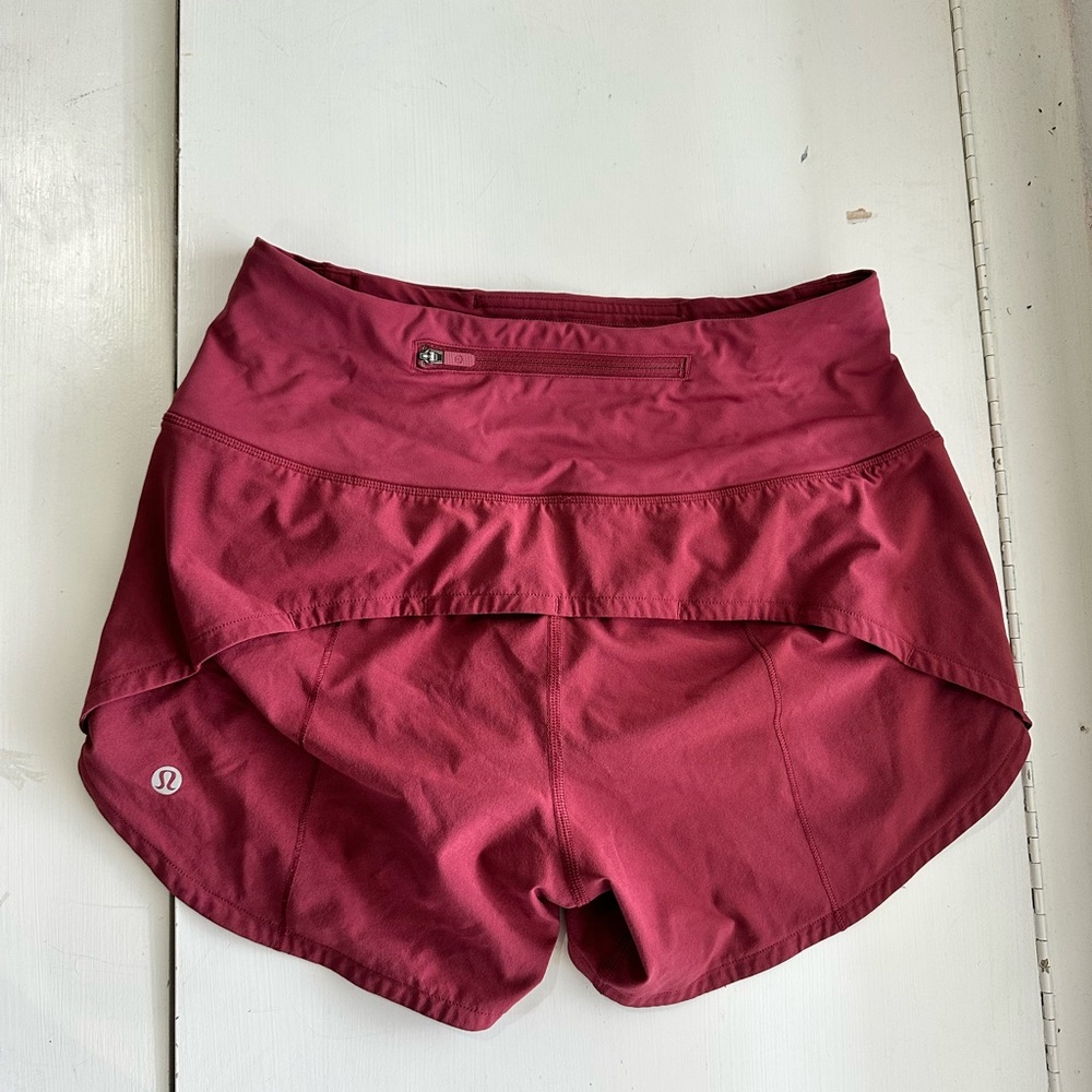 Lululemon size 4 speed up shorts; color: mulled wine